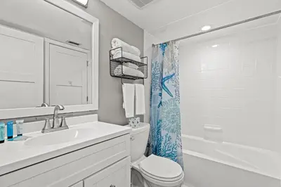a bathroom with a sink and a toilet and a shower at Commodore 0403 in Panama City Beach