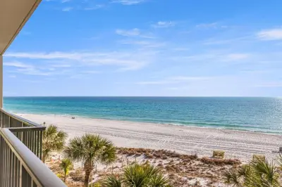 a view of a beach with palm trees and the ocean at Commodore 0403 in Panama City Beach