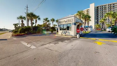 an empty street with a stop sign and a building at Commodore 0403 in Panama City Beach