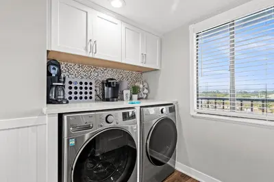 a washing machine in a kitchen with a window at Commodore 0403 in Panama City Beach