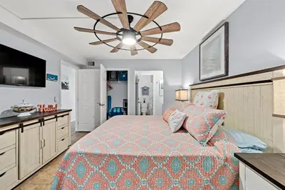 a bedroom with a bed and a ceiling fan at The Summit - Family Friendly Vacation! in Panama City Beach