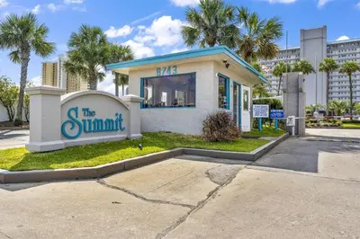 a building with a sign that reads the summit at The Summit - Family Friendly Vacation! in Panama City Beach