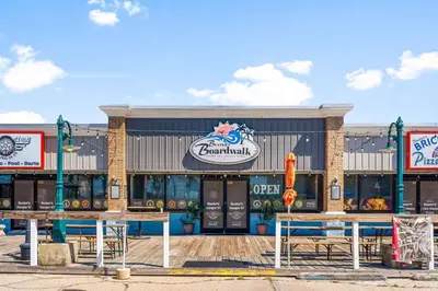 a seafood restaurant with tables in front of a building at Sunset Nirvana in Panama City Beach