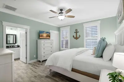 a bedroom with a bed and a ceiling fan at Sunset Nirvana in Panama City Beach