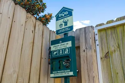 two signs on a pole in front of a fence at Sunset Nirvana in Panama City Beach
