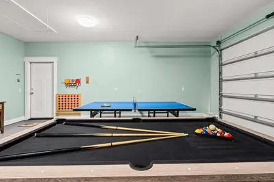 a ping pong table in a room with a ping pong ball at Sunset Nirvana in Panama City Beach