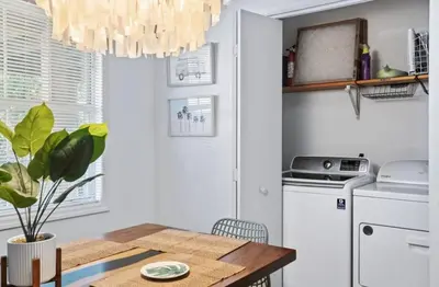 a kitchen with a dining table and a chandelier at Lux min to Beach and Hospital with Hot Tub in Panama City