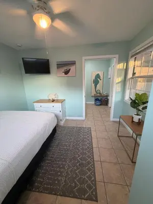 a bedroom with a bed and a ceiling fan at Lux min to Beach and Hospital with Hot Tub in Panama City