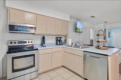 a kitchen with a stove and a sink at Lux min to Beach and Hospital with Hot Tub in Panama City