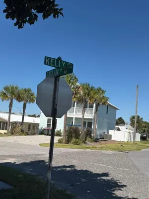 a stop sign with street signs on top of it at Lux min to Beach and Hospital with Hot Tub in Panama City