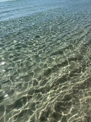 a close up of the water on a beach at Lux min to Beach and Hospital with Hot Tub in Panama City