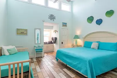 a bedroom with two beds and a bathroom at Emerald Seascape! Gulf front! Dog friendly! in Panama City Beach