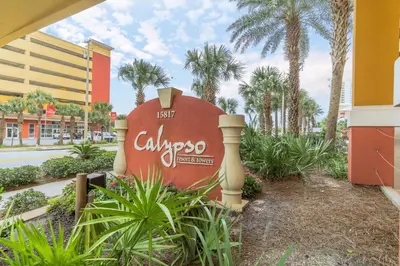 a large sign in front of a building with palm trees at It’s Sea-esta Time! Sleep, Sun, & Sea on the 9th Floor! Sleeps 6! Beachfront! in Panama City Beach