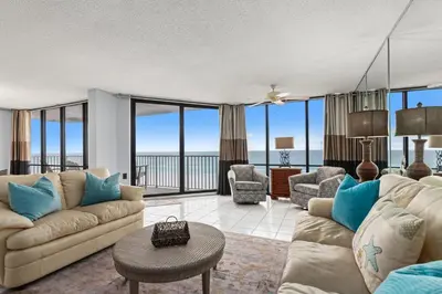 a living room with a couch and a table at Buoy Oh Buoy! Sun, Sand, and Smiles Await! Sleeps 8! in Panama City Beach