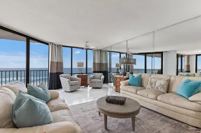 a living room with a couch and a table at Buoy Oh Buoy! Sun, Sand, and Smiles Await! Sleeps 8! in Panama City Beach