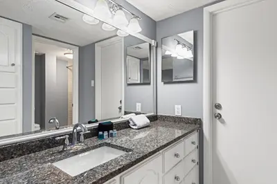 a bathroom with two sinks and a large mirror at Buoy Oh Buoy! Sun, Sand, and Smiles Await! Sleeps 8! in Panama City Beach