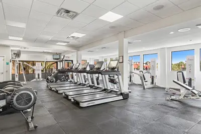 a gym with treadmills and elliptical machines at Buoy Oh Buoy! Sun, Sand, and Smiles Await! Sleeps 8! in Panama City Beach