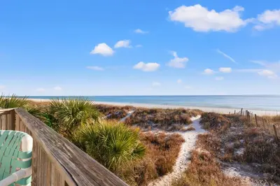a view of a beach with a chair and the ocean at GO-JO Getaway! Coastal Comfort, 2BR Beachfront Townhouse, Sleeps 6 in Panama City Beach