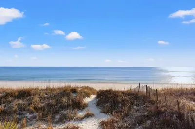 an empty beach with the ocean in the background at GO-JO Getaway! Coastal Comfort, 2BR Beachfront Townhouse, Sleeps 6 in Panama City Beach
