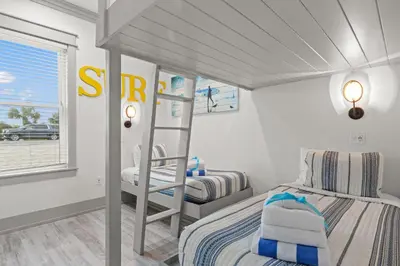 a bedroom with a bunk bed and a ladder at Keep Calm & Pool On at Peaceful Easy Feeling! Sleeps 20! in Panama City Beach