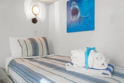 a bedroom with a bed with towels on it at Keep Calm & Pool On at Peaceful Easy Feeling! Sleeps 20! in Panama City Beach