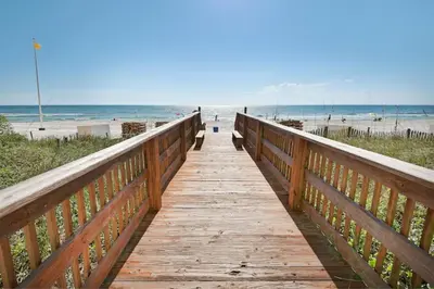 a wooden boardwalk leading to the beach at Splash, Relax & Repeat at Dolphin View Retreat! Beachfront! Sleeps 9! in Panama City Beach