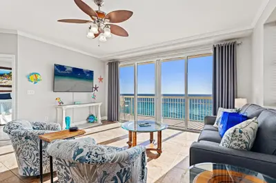 a living room with a view of the ocean at Splash, Relax & Repeat at Dolphin View Retreat! Beachfront! Sleeps 9! in Panama City Beach