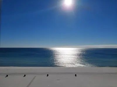 a view of the ocean with people walking on the beach at Come enjoy some Seawaves! 2BR 25BA Sleeps 8! Coastal Townhome w/Beachview! in Panama City Beach