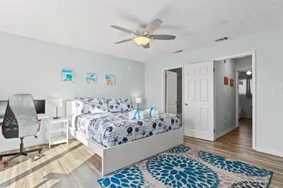a bedroom with a bed and a ceiling fan at Stay at The Salty Palm! 2BR 15BA Sleeps 7 in Panama City Beach