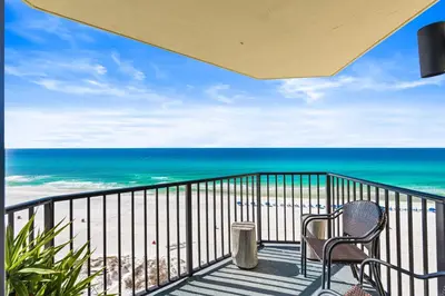 a balcony with two chairs and the ocean at Beachfront! Balcony Views! Pools and Beach Access in Panama City Beach