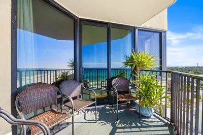 a balcony with chairs and views of the ocean at Beachfront! Balcony Views! Pools and Beach Access in Panama City Beach