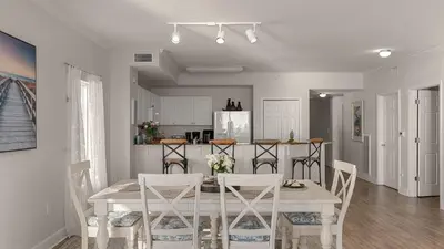 a kitchen and dining room with a table and chairs at Tidewater Horizon by Avantstay Beachfront Condo Indoor Pool Spa Amenities Movie Theater Near Pier Park in Panama City Beach