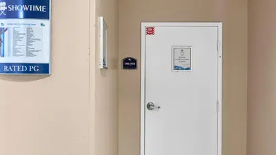 a door in a room with a sign on the wall at Tidewater Horizon by Avantstay Beachfront Condo Indoor Pool Spa Amenities Movie Theater Near Pier Park in Panama City Beach