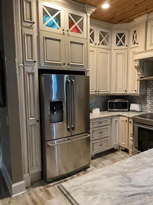 a stainless steel refrigerator in a kitchen with white cabinets at Gulfs Edge Townhome #16 - Sealee by Emerald Coast Retreats in Panama City Beach