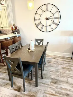 a dining room with a table and a large clock on the wall at Gulfs Edge Townhome #16 - Sealee by Emerald Coast Retreats in Panama City Beach