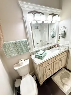 a bathroom with a toilet and a sink and a mirror at Gulfs Edge Townhome #16 - Sealee by Emerald Coast Retreats in Panama City Beach