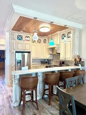 a kitchen with a large island with bar stools at Gulfs Edge Townhome #16 - Sealee by Emerald Coast Retreats in Panama City Beach