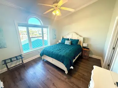 a bedroom with a bed and a ceiling fan at Gulfs Edge Townhome #16 - Sealee by Emerald Coast Retreats in Panama City Beach