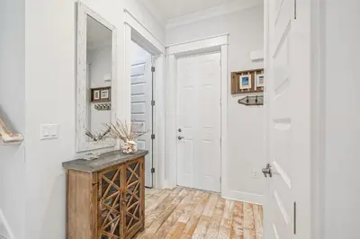a hallway with a mirror and a wooden table at TL SEA 88 Pine Lands Loop W Unit A in Inlet Beach
