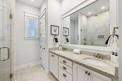a white bathroom with two sinks and a mirror at TL SEA 88 Pine Lands Loop W Unit A in Inlet Beach