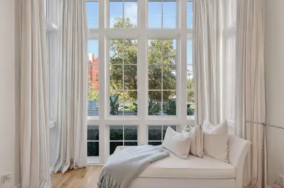 a white couch in front of a large window at BAH Casa in Inlet Beach