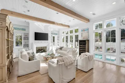 a living room with white furniture and a fireplace at BAH Casa in Inlet Beach