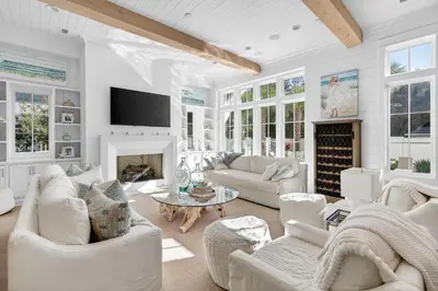 a living room with white furniture and a fireplace at BAH Casa in Inlet Beach