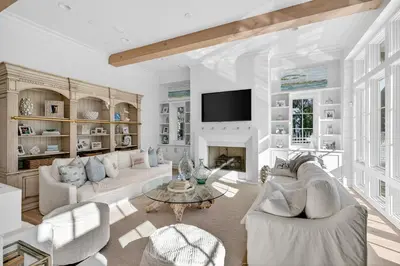 a living room with white furniture and a fireplace at BAH Casa in Inlet Beach