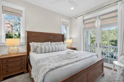 a bedroom with a large bed and two windows at BAH Casa in Inlet Beach