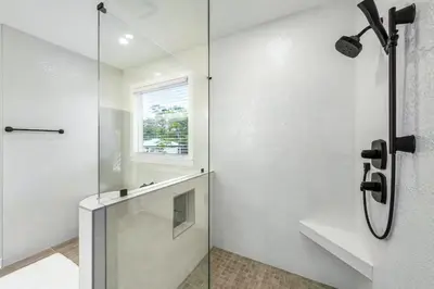 a shower with a glass door in a bathroom at Where Waters Meet by Travel Life Vacations in Watersound Beach