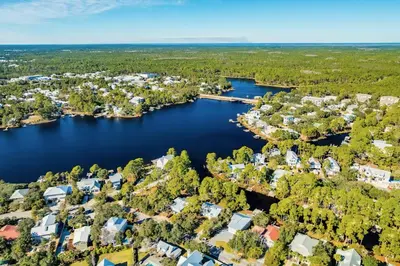 an aerial view of a lake with houses at Where Waters Meet by Travel Life Vacations in Watersound Beach