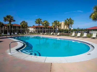 a swimming pool at a resort with palm trees at Horizon South 59-202 in Panama City Beach