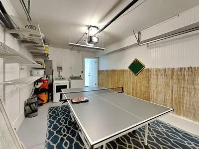 a ping pong table in the middle of a room at Tiki Tango Hideaway in Panama City Beach