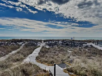 a path leading to the beach with the ocean in the background at Tiki Tango Hideaway in Panama City Beach